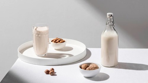 High angle milk bottle with glass tray walnuts
