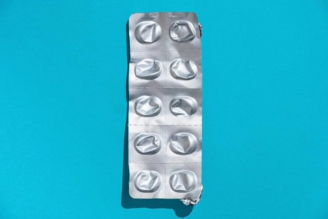 Empty tablet blister pack against a monochrome background