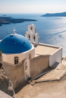 Iconic blue-domed church and Three-bells of Fira belfry with sea view