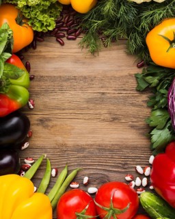 Top view vegetables assortment with wooden background