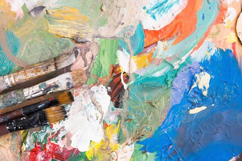 Elevated view paint brushes colorful messy background