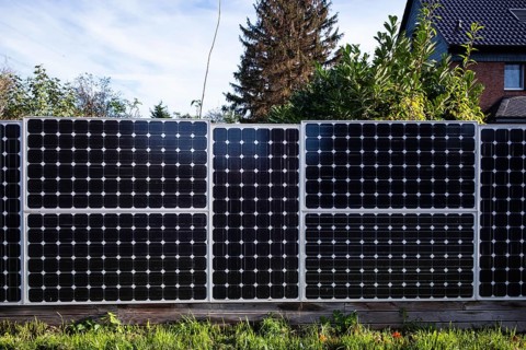 Solar panels as a garden fence and privacy screen of a house on a street in Langenfeld