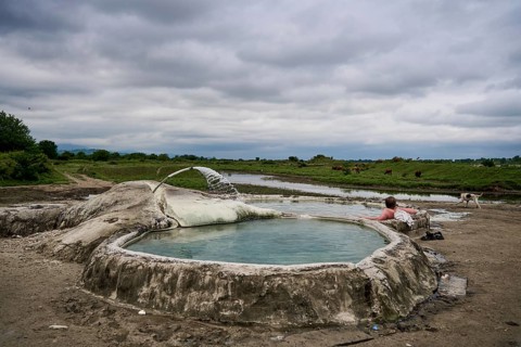 Tourist bathing in springs of Amaghleba