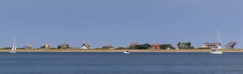 Sailing boats and beach houses along the Baltic Sea on the peninsula Graswarder