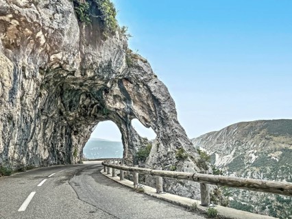 Photo with reduced dynamic range saturation HDR of view of rock arch rock formation with passage on road Route de Gentelly