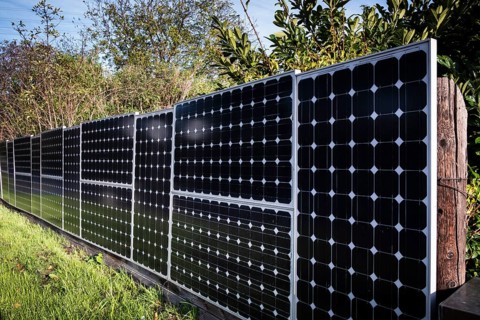 Solar panels as a garden fence and privacy screen of a house on a street in Langenfeld