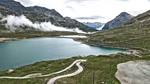Photo with reduced dynamics saturation HDR of mountain lake at mountain pass alpine mountain road alpine road pass road Bernina Pass Bernina Pass