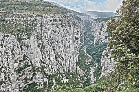 Photo with reduced dynamic range saturation HDR of view into steep narrow rocky gorge Gorges du Verdon Grand Canyon de Verdon Verdon gorge