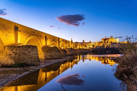 Roman bridge over the river Rio Guadalquivir and the Mezquita