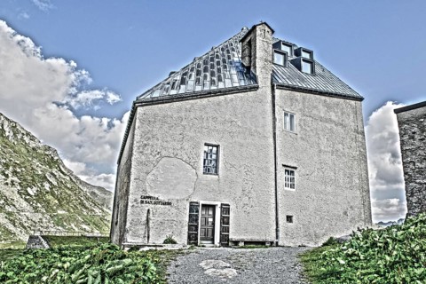 Photo with reduced dynamic range saturation HDR of view on historic hotel accommodation Ospizio San Gottardo Sankt Gotthard Hospiz with historic buildings from year 1237 13th century on 2091 meter hig...