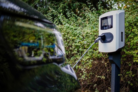 An e-car being charged at a private charging station