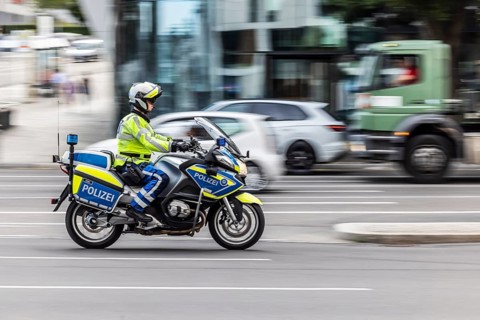 Police motorbike at night in front of urban environment