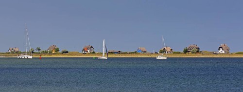 Sailing boats and beach houses along the Baltic Sea on the peninsula Graswarder