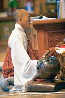 Korean monk praying in the prayer hall
