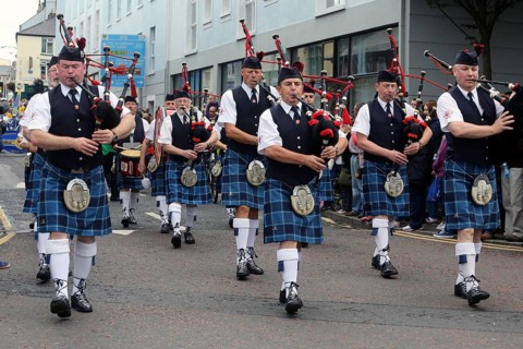 Irish bagpipers in kilts march at the head of the final parade to mark the close of Fleadh Cheoil na hEireann