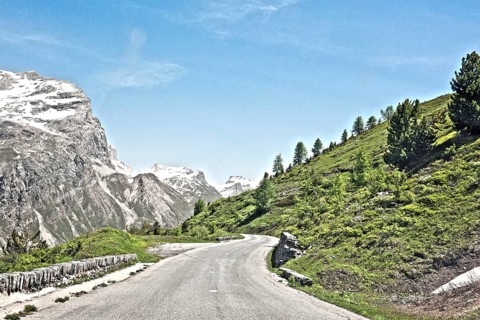 Photo with reduced dynamic range saturation HDR of mountain pass alpine mountain road alpine road pass road pass near tree line in landscape of high alps