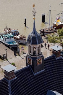 Ships in the museum harbour with the tower of the Alte Waage seen from the town hall tower