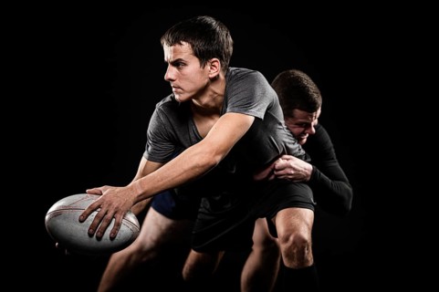 Front view male rugby players with ball