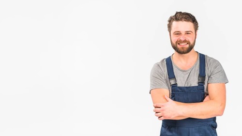 Man overall smiling with crossed arms