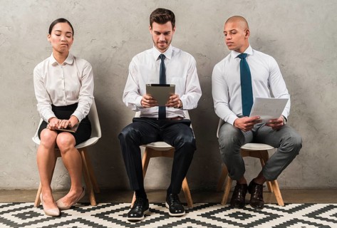 Jealous businesswoman sitting near businessman using digital tablet
