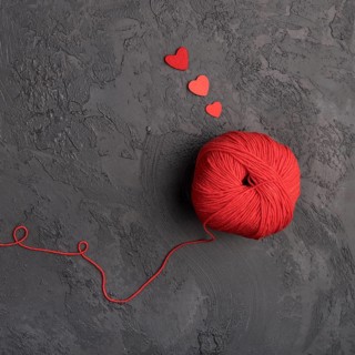 Red wool ball slate background