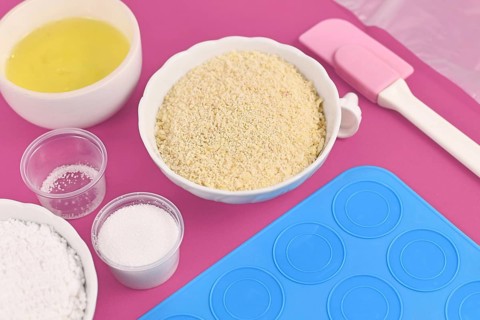 Ingredients for making homemade French Macaron sweets including powdered sugar