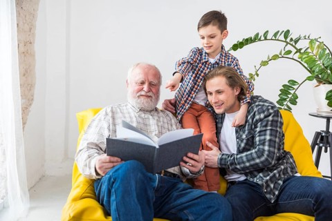 Multigenerational men watching album
