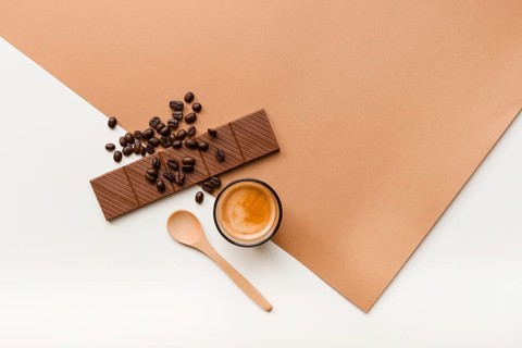 Roasted coffee beans chocolate bar coffee glass with spoon background