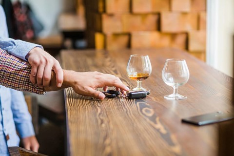 Man avoiding her friend taking car keys table