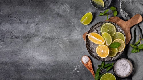 Plate with lime lemon slices flat lay