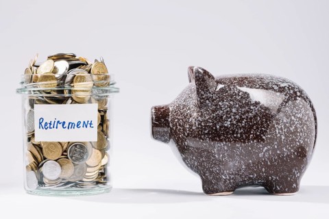 Piggybank near retirement glass container full coins