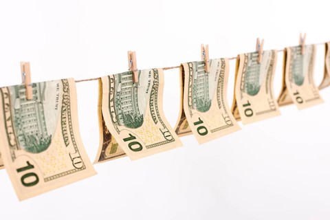 Side view banknotes hanging clothesline