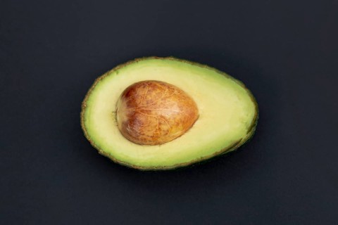 Top view avocado half with pit