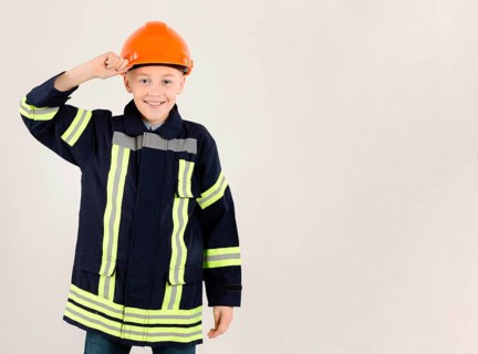 Adorable young fireman copy space