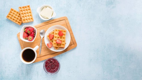 Board with waffles fruits with copy space