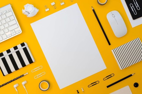 Flat lay office supplies with mouse headphones
