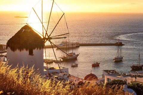Golden sunset over sea horizon in Mykonos