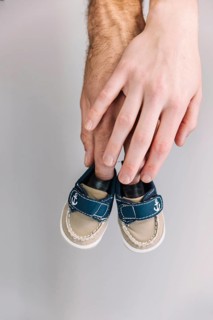 Hand holding baby shoes