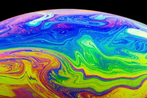 Gradient multicolored soap bubble black background