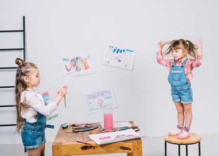 Little girl painting posing girl chair