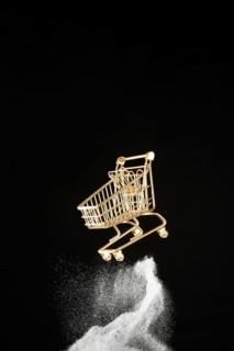 Golden shopping cart white glitter black background