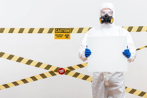 Man hazmat suit with blank sign