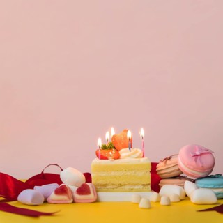 Decorated cakes with candies marshmallow macarons yellow desk