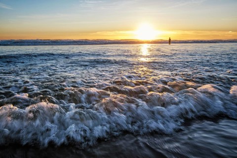 Atlantic ocean sunset with surging waves at Fonte da Telha beach