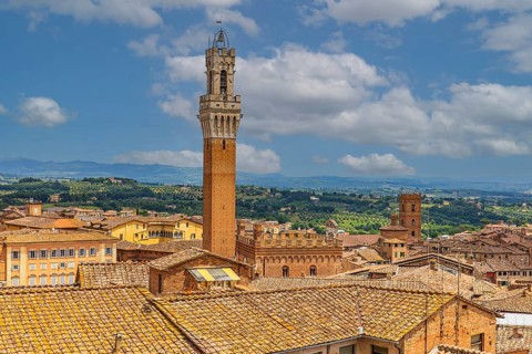 Above the rooftops of Siena with a view of the Torre del Mangia bell tower
