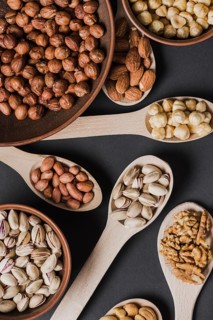 Close up spoons bowls with nuts