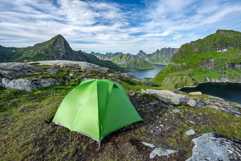 Green tent in the mountains