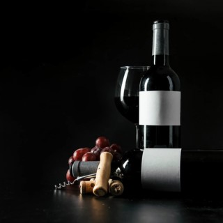 Corkscrew grape near bottles wineglass
