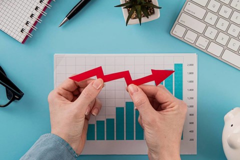 Top view business items with growth chart hands holding arrow