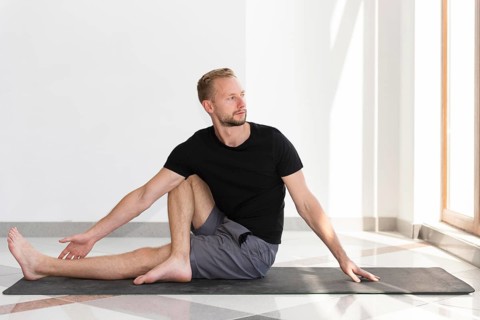 Full shot man stretching indoor